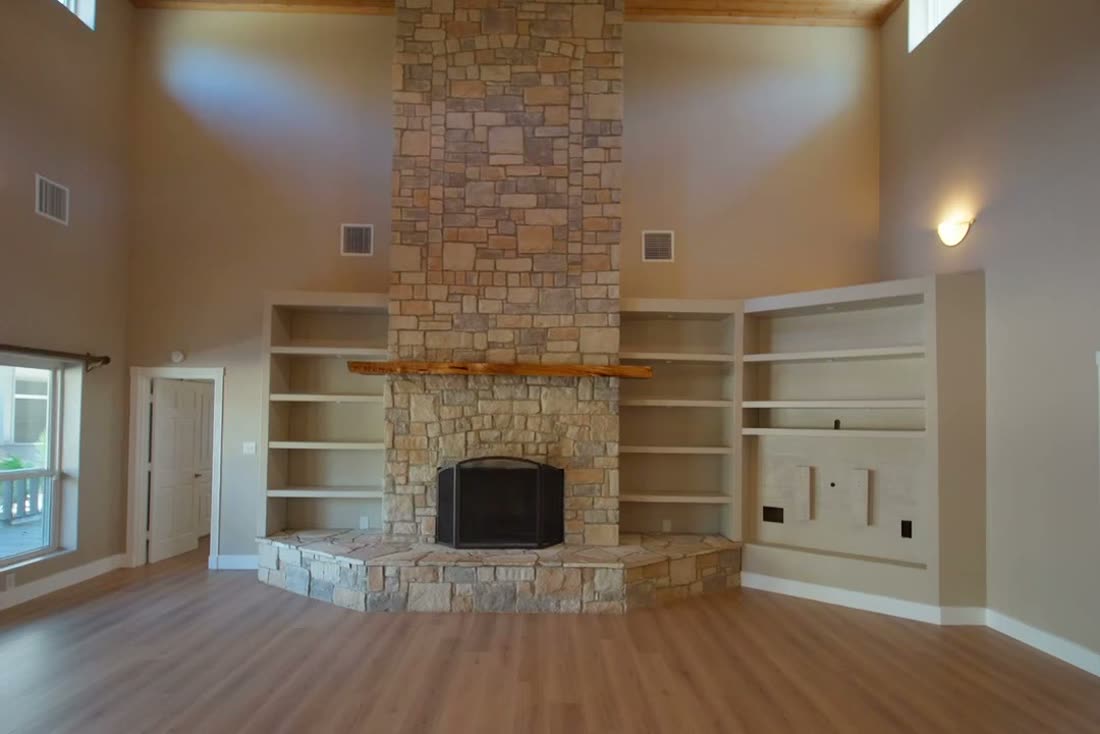 Living room with stone fireplace in Huffman